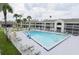 Resort style pool surrounded by palm trees, lounge chairs and multiple levels of condo style balconies at 5245 W Irlo Bronson Memorial Hwy # 194, Kissimmee, FL 34746