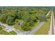 Scenic aerial view of a home surrounded by lush greenery and trees with railroad tracks and a highway close by at 5851 Se Drew Rd, Belleview, FL 34420
