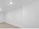 Basement area with white walls and ceiling with recessed lighting at 5851 Se Drew Rd, Belleview, FL 34420
