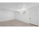 Basement area with tile flooring, white door and small window offering natural light at 5851 Se Drew Rd, Belleview, FL 34420