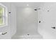 Bright, walk-in shower features a rain shower head, and is complimented by a sleek design at 5851 Se Drew Rd, Belleview, FL 34420