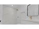 Elegant bathroom features a marble shower with gold accents and modern fixtures at 5851 Se Drew Rd, Belleview, FL 34420