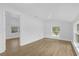 Bedroom with wood-look flooring, large window and vaulted ceiling at 5851 Se Drew Rd, Belleview, FL 34420