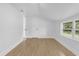 Bedroom with sloped ceilings, laminate flooring and window with wooded view at 5851 Se Drew Rd, Belleview, FL 34420