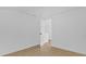 White bedroom showcasing neutral walls, wood floors, natural light and arched door at 5851 Se Drew Rd, Belleview, FL 34420