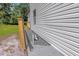 View of the exterior foundation, showcasing the building's construction and the surrounding landscape with new siding at 5851 Se Drew Rd, Belleview, FL 34420