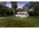 A nighttime view of the home highlighting the exterior features including the yard and the front entryway at 5851 Se Drew Rd, Belleview, FL 34420