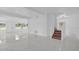 Open-concept living area with modern staircase, bright and airy, perfect for entertaining and comfortable living at 5851 Se Drew Rd, Belleview, FL 34420
