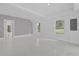 Spacious living area with large windows, neutral paint, and modern finishes, creating a bright and airy atmosphere at 5851 Se Drew Rd, Belleview, FL 34420