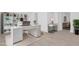 Modern office space with sleek white furniture, built-in shelving, and ample natural light for a productive workspace at 5851 Se Drew Rd, Belleview, FL 34420