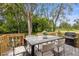 Outdoor dining area featuring a grill, dining table, and chairs for outdoor gatherings and al fresco dining at 5851 Se Drew Rd, Belleview, FL 34420