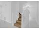Bright, modern staircase featuring wood steps and white railings, complemented by sleek, light-filled interiors at 5851 Se Drew Rd, Belleview, FL 34420