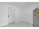 Bright laundry room provides a door to backyard and water heater at 5851 Se Drew Rd, Belleview, FL 34420