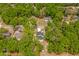 Aerial view of a newly constructed home nestled among mature trees at 610 E Euclid Ave, Deland, FL 32724
