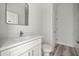 Bathroom featuring a vanity with quartz countertop, sink and faucet, toilet, and doorway to shower area at 610 E Euclid Ave, Deland, FL 32724