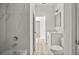 Bathroom featuring a combination shower and bathtub with tile surround, vanity, and toilet at 610 E Euclid Ave, Deland, FL 32724