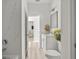 Modern bathroom with white vanity, decorative mirror, stylish fixtures, and an adjoining shower/tub at 610 E Euclid Ave, Deland, FL 32724