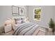 Comfortable bedroom featuring soft gray tones, modern decor, and natural light from the window at 610 E Euclid Ave, Deland, FL 32724