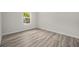Bedroom with a window featuring hardwood floors and white walls at 610 E Euclid Ave, Deland, FL 32724