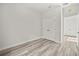 A bedroom offers wood-look floors and a closet with double doors at 610 E Euclid Ave, Deland, FL 32724