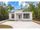 Newly renovated one-story home featuring a white exterior, minimalist design, and black-trimmed windows at 610 E Euclid Ave, Deland, FL 32724