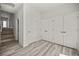 Hallway with stairs and a wall of closets with double doors at 610 E Euclid Ave, Deland, FL 32724
