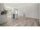 Open kitchen and living room features hardwood floors, white walls, and a central island at 610 E Euclid Ave, Deland, FL 32724