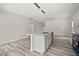 Spacious open-concept kitchen with an island featuring stainless steel appliances, hardwood floors, and white walls at 610 E Euclid Ave, Deland, FL 32724
