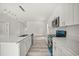 Modern kitchen with an island featuring stainless steel appliances, hardwood floors, and white walls at 610 E Euclid Ave, Deland, FL 32724