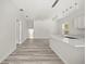Large open concept living room featuring an island, stainless steel appliances, hardwood floors, and white walls at 610 E Euclid Ave, Deland, FL 32724