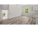 Bright living room features hardwood floors, white walls, a window, and staircase at 610 E Euclid Ave, Deland, FL 32724