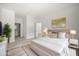 Serene primary bedroom with neutral tones, stylish decor, and an ensuite bathroom at 610 E Euclid Ave, Deland, FL 32724