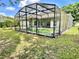 Backyard features the screened-in pool and a view of the backyard and surrounding nature at 671 Carey Way, Orlando, FL 32825