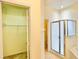 Bathroom displaying a closet and a glass-enclosed shower, with neutral tiling and a clean aesthetic at 671 Carey Way, Orlando, FL 32825