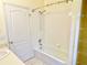 Bathroom featuring shower over tub combination with white tiled walls at 671 Carey Way, Orlando, FL 32825