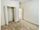Bedroom with carpeting, an open closet and a view into the kitchen at 671 Carey Way, Orlando, FL 32825