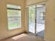 Bright bedroom with a large sliding glass door leading to the screened patio and view of backyard at 671 Carey Way, Orlando, FL 32825