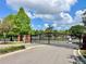 Gated entrance to the community featuring brick columns and landscaping, ensuring privacy and security for residents at 671 Carey Way, Orlando, FL 32825