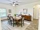 Formal dining room with wood-look floors, a dining table set, and elegant decor at 671 Carey Way, Orlando, FL 32825