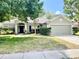 Charming single-story home featuring a well-maintained lawn, mature trees and a two car garage, showcasing curb appeal at 671 Carey Way, Orlando, FL 32825