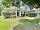 Charming single-story home with a manicured front yard and beautiful landscaping at 671 Carey Way, Orlando, FL 32825