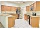 Well-equipped kitchen with stainless steel appliances, light wood cabinets, and tile flooring, offering functionality and style at 671 Carey Way, Orlando, FL 32825