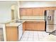 Functional kitchen featuring stainless steel appliances, light wood cabinets, and ample counter space for all your cooking needs at 671 Carey Way, Orlando, FL 32825