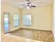 Bright living area with wood-look floors, a ceiling fan, and access to the pool area at 671 Carey Way, Orlando, FL 32825