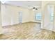 Open living area with stylish flooring, neutral walls, ceiling fan and abundant natural light creating a warm atmosphere at 671 Carey Way, Orlando, FL 32825