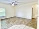 Open living area with wood-look floors, ceiling fan, and natural light at 671 Carey Way, Orlando, FL 32825