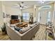 Cozy living room with a comfortable sectional sofa, wood-look floors, and a large window for natural light at 671 Carey Way, Orlando, FL 32825