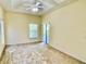 Spacious main bedroom featuring tray ceilings, ceiling fan and sliding glass doors leading to the pool at 671 Carey Way, Orlando, FL 32825