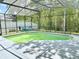 Screened pool area featuring an enclosed pool and view of backyard and trees at 671 Carey Way, Orlando, FL 32825