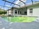 View of the screened-in pool with ceiling fans overlooking the outdoor patio at 671 Carey Way, Orlando, FL 32825